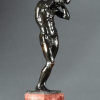 Alt text: Bronze sculpture of a nude figure holding a rock above his head