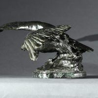Alt text: Bronze sculpture of an eagle with outstretched wings