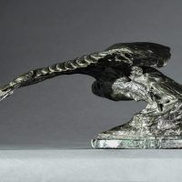 Alt text: Bronze sculpture of an eagle with outstretched wings