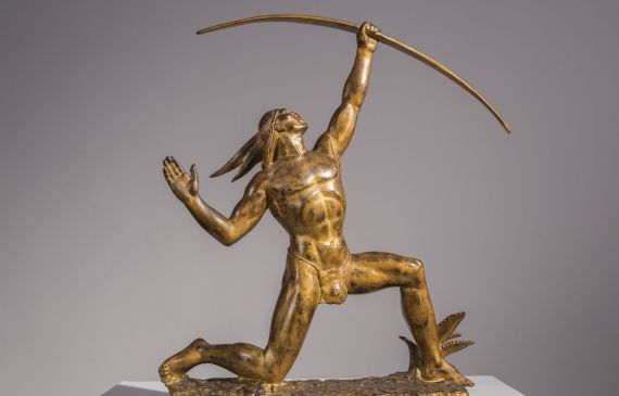 Alt text: Bronze sculpture of a Native American kneeling on one knee and shooting an arrow up into the sky