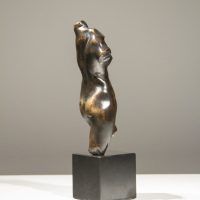 Alt text: Bronze sculpture of a twisting female torso