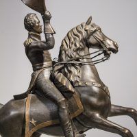 Alt text: Bronze sculpture of Andrew Jackson on a horse with its front legs lifted off the ground, detail