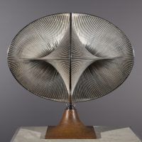 Alt text: Abstract sculpture with warped geometric shapes that create an optical illusion