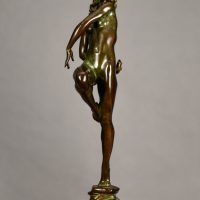 Alt text: Bronze sculpture of a nude woman skipping and holding a fish in one hand
