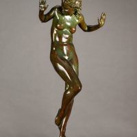 Alt text: Bronze sculpture of a nude woman posing with hands up