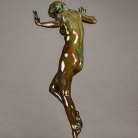 Alt text: Bronze sculpture of a nude woman posing with hands up