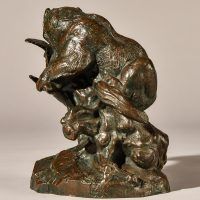 Alt text: Bronze sculpture of a bear catching an owl in his maw