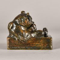 Alt text: Bronze sculpture of a bear eating fish in a tub