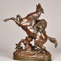 Alt text: Bronze sculpture of a horse rearing on his hind legs as a lion jumps on his back to attack him