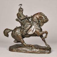Alt text: Bronze sculpture of a Tartar warrior wearing armor and riding on horseback