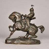 Alt text: Bronze sculpture of a Tartar warrior wearing armor and riding on horseback
