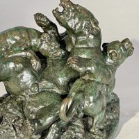 Alt text: Bronze sculpture of a bear attacked by hounds