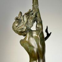 Alt text: Bronze sculpture of a woman