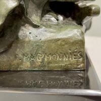 Alt text: Detail of a bronze sculpture of a pioneer woman