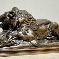 Alt text: sculpture of a lion over a dead animal