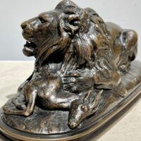 Alt text: sculpture of a lion over a dead animal, detail