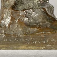 Alt text: Detail of eagle sculpture signature and inscription reading 