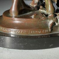 Alt text: bronze sculpture, signature detail