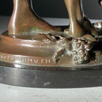 Alt text: bronze sculpture, signature detail