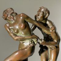 Alt text: bronze sculpture of two people, detail