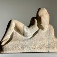 Alt text: Marble carving of a reclining nude woman