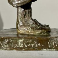 Alt text: Bronze sculpture base, artist signature
