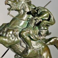 Alt text: Bronze sculpture of a horseman killing a lion