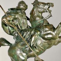 Alt text: Bronze sculpture of a horseman killing a lion