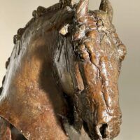 Alt text: Bronze sculpture of a horse's head