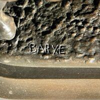 Alt text: Signature detail of a bronze sculpture
