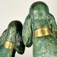 Alt text: Bronze sculpture of two poodles, detail