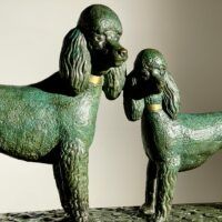 Alt text: Bronze sculpture of two poodles