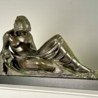 Alt text: Bronze sculpture of a reclining woman