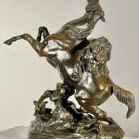 Alt text: Bronze sculpture of a lion attacking a horse