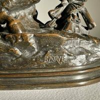 Alt text: Signature detail of bronze sculpture