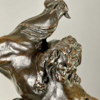 Alt text: Bronze sculpture of a lion attacking a horse
