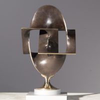 Alt text: Abstract bronze sculpture of two distorted and conjoined squares and one circle