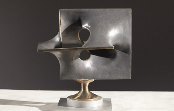 Alt text: Abstract bronze sculpture of two distorted and conjoined squares