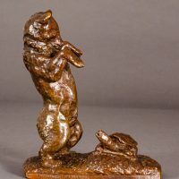 Alt text: Bronze sculpture of a bear standing on his hind legs scaring a turtle, side view