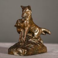 Alt text: Bronze sculpture of two coyotes nuzzling each other