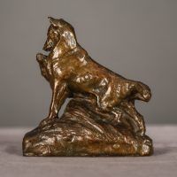 Alt text: Bronze sculpture of two coyotes nuzzling each other