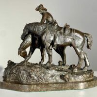 Alt text: Bronze sculpture of a man with horses