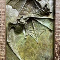 Alt text: Relief of two flying bats