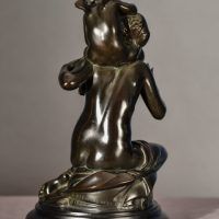 Alt text: Bronze sculpture of Psyche seated with Cupid on her shoulders