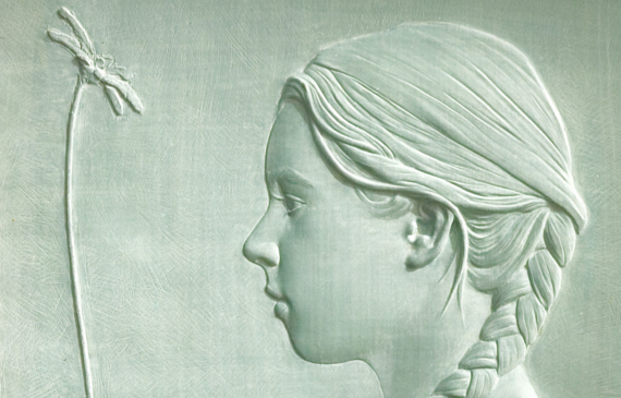 Alt text: Relief of a female head in side profile