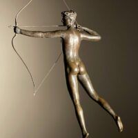 Alt text: Bronze sculpture of a woman holding a bow and arrow