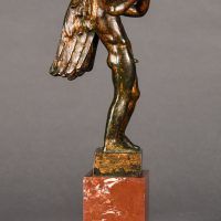 Alt text: Bronze sculpture of an angel playing flute