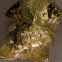 Alt text: Detail of sculpin sculpture with artist signature and copyright