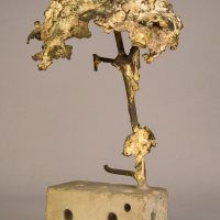 Alt text: Welded bronze sculpture shaped like a tree mounted on a slag block, angled view