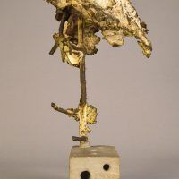 Alt text: Welded bronze sculpture shaped like a tree mounted on a slag block, frontal view